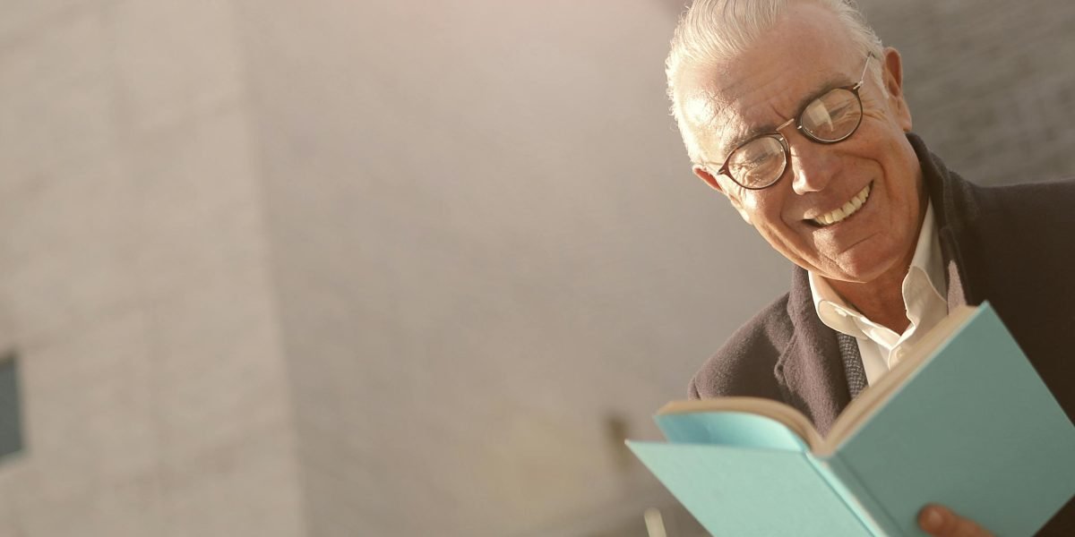 A person enjoying a contemporary humorous novel in a comfortable setting.