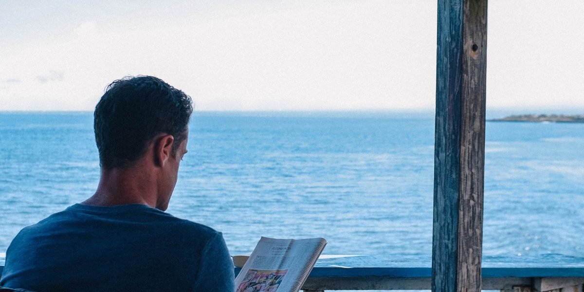 A person enjoying a humorous novel, captured mid-laughter, reflecting deep engagement with the content.