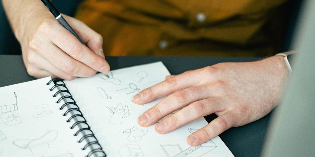 An individual deep in thought, brainstorming creative concepts for a new project.