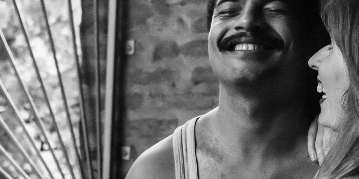 Two individuals engaged in conversation, sharing a genuine moment of laughter and connection.