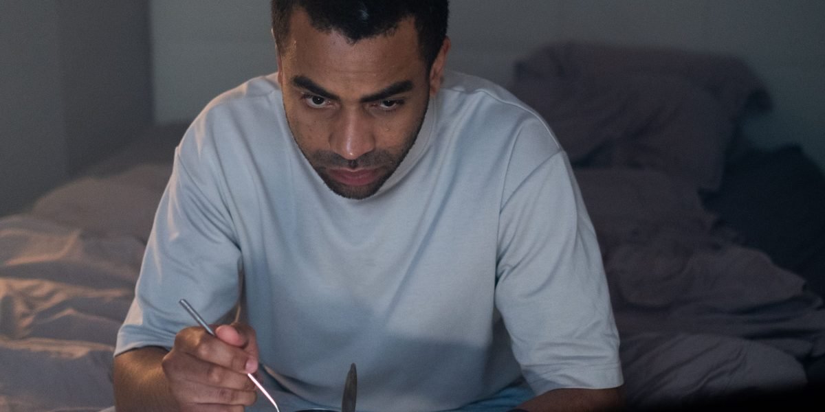 A person comfortably relaxing at home, watching television alone, symbolizing the desire for quiet and personal entertainment.